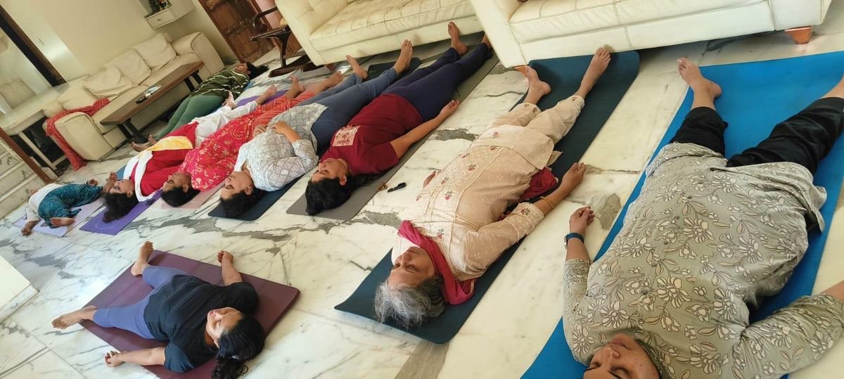 Students resting in deep relaxation, yoga nidra